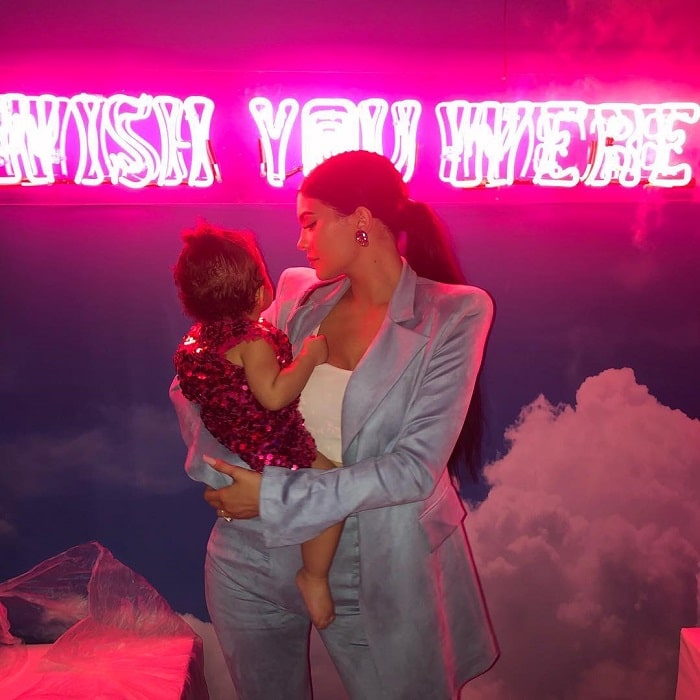 Kylie with stormi wearing a pastel blue coat and pant.