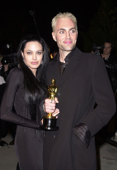 James Haven and his sister Angelina Jolie posing for a photo with Angelina Oscar award.