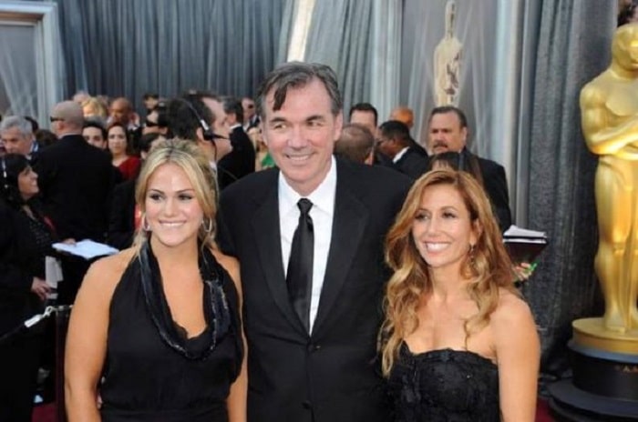 Tara with her husband and her step daughter at a red carpet event.