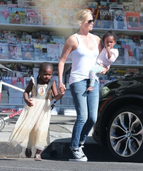 August in her mama's arms while her sibling, Jackson is seen rocking a dress.