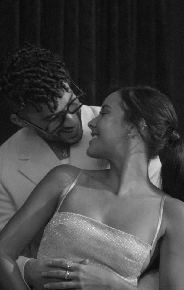 Gabriela Berlingeri with her boyfriend Bad Bunny wearing a strap bodycon white dress