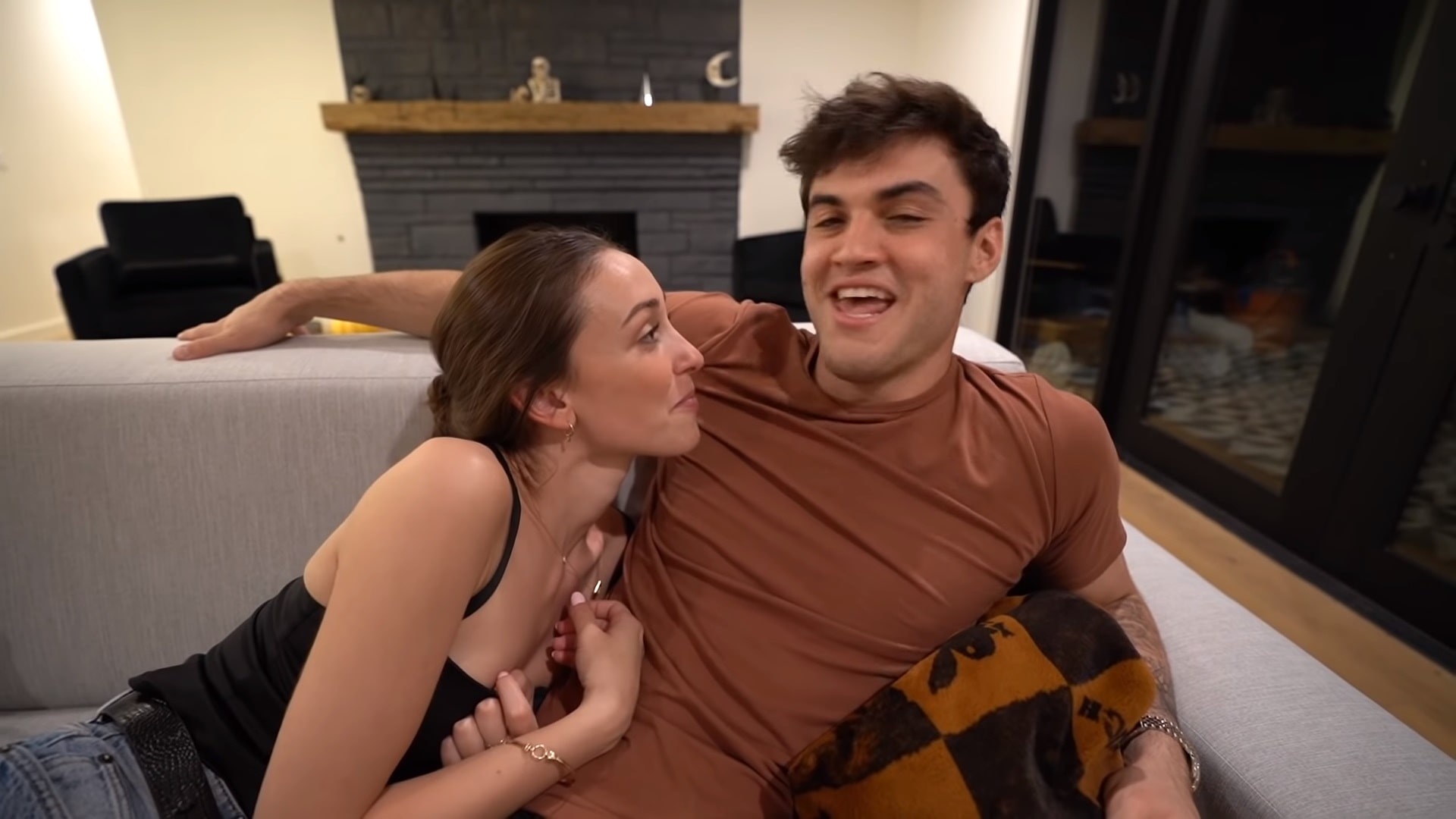Ethan's wearing brown tee and kristina's wearing black top.