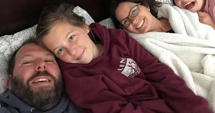 Georgia is  wearing maroon color hoodie.