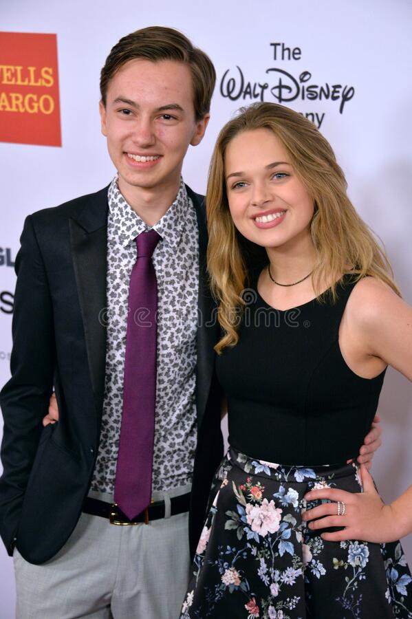 Hayden Byerly with his girlfriend Alyssa Jirrels wearing a suit pant