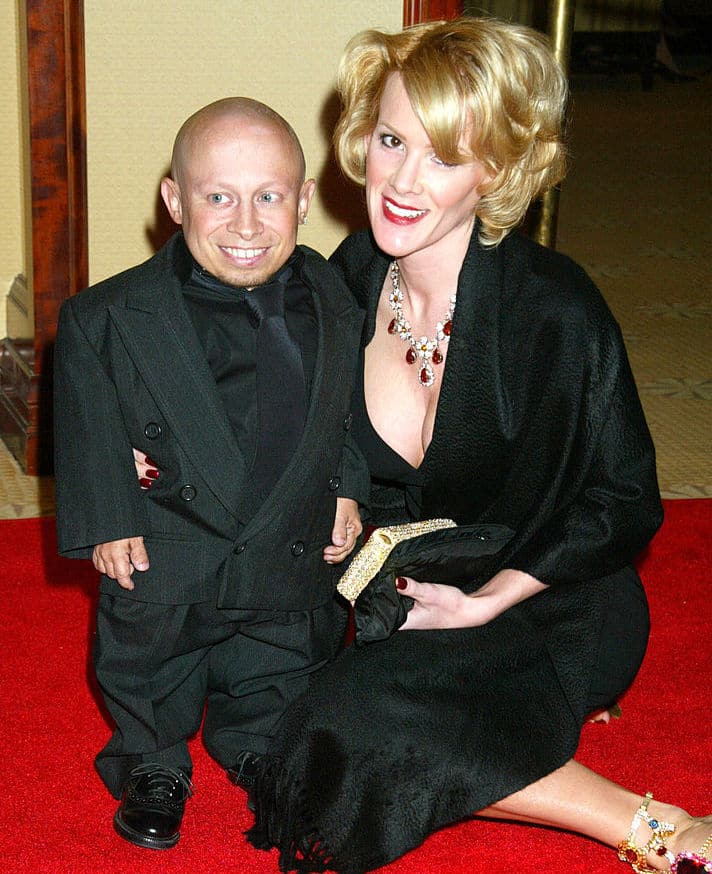 Genevieve Gallen with her ex-husband Verne Troyer wearing a black dress and a diamond necklace