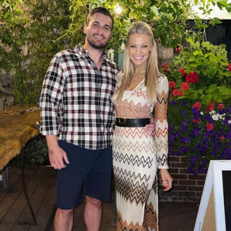 Carley Shimkus and her husband Peter Buchignani posing for a photoshoot. 