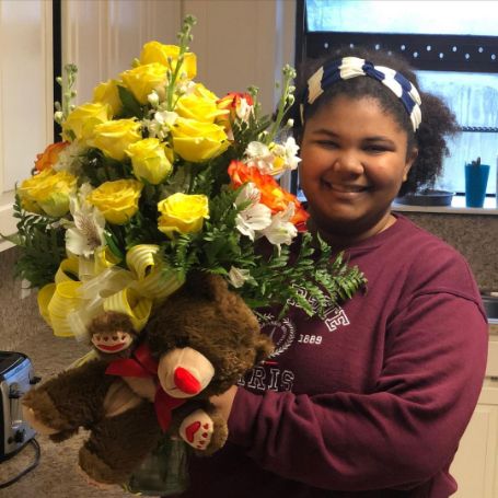 Wynfrey Crews holding a bouquet. 