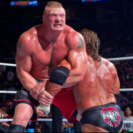 Brock Lesnar wrestling with Tripple H.