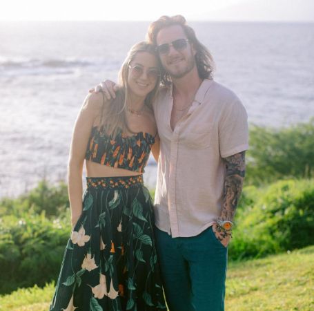Tyler Hubbard and Hayley Stommel posing for a photo shoot. 