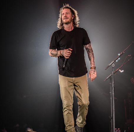 Photo of Tyler Hubbard while holding the mike.