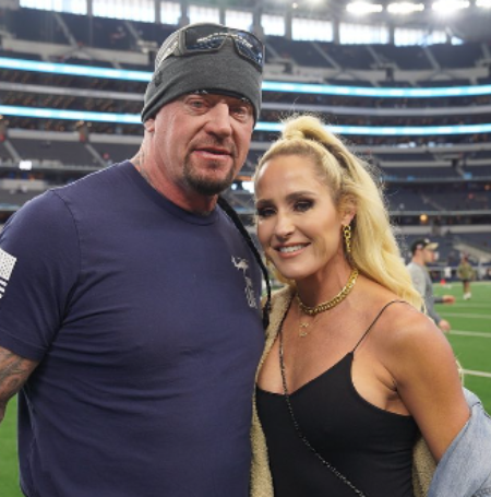 The Undertaker is with his daughter.